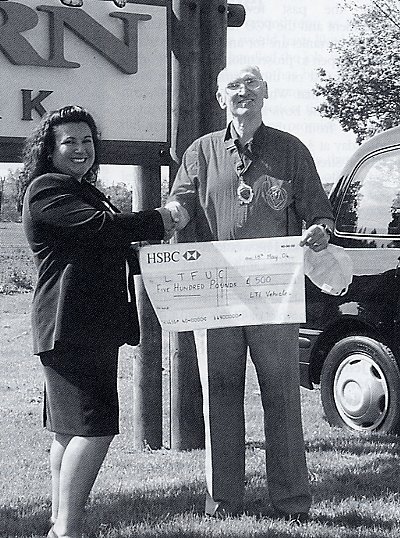 LTI's Ros McGill presents cheque to DaC's Bill Tyzack