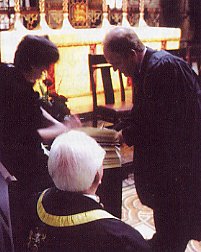 Brian Rice signs the book before witness Clerk Mary Whitworth and Master John Rennie.