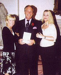Together with proud wife Brenda (I) and daughter Carla, Brian Rice shows Call Sign his certificate.