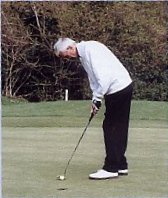 Hair gleaming in the sunlight, Allen Togwell gets ready to putt