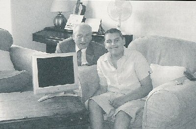 Adam smiles as Tom Whitbread presents him with the television