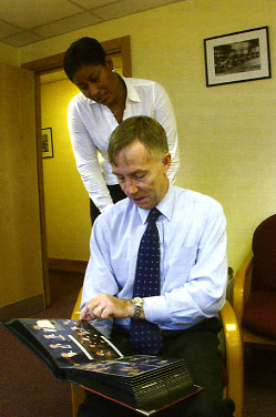 Mary Dowdye watches as Roy Ellis looks at Call Sign's parting gift to him