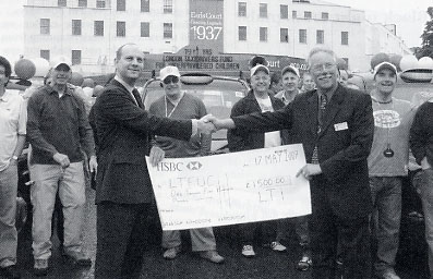 David Lessman receives a cheque for the LTFUC from LTI's Richard Daniels