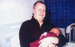Len's son Gavin holds Liam on the day he was born