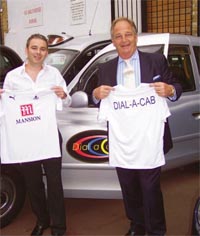 Brian Rice presents the Spurs tops to Steve Bryant, who will take them to Uganda and give them to a disabled childrens team.