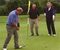 Martyn Madden (Y97) putts as Alan Callaghan (L86) and Eugene Smith (E90) look on