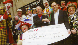 Richard Daniels presents David Lessman with a cheque for 1500 in front of some rather strange looking witnesses!