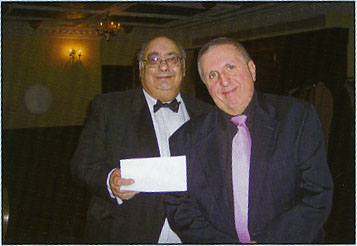 Feeling silly, Alan presents Russell Poluck with what should have been 100 crossword prize!
