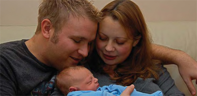 New parents Billy and Sam with baby Charlie