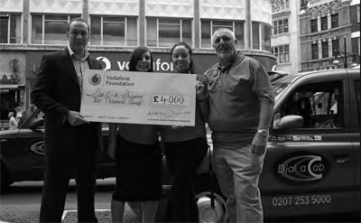 Stuart, Vodafone RM (left) and his two assistants present Bob Heath with a wonderful cheque for 4000