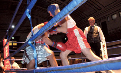 Mickey (red shorts) on the attack forces his opponent into a corner