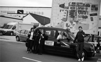 Jim Rainbird drives the taxi alongside the 3 winners and their teacher Pic Christianblack.com