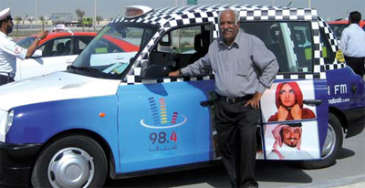 Under cloudless skies, Abdul waits for passengers in his TX4