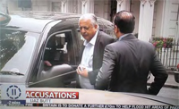 The High Commissioner leaves Tonys cab while a security man tries to stop the Pressmen getting to him. 