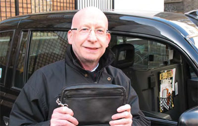 Larry and his new money bag. He won't be leaving this one in the cab
